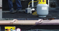 <John Uske repairing an AC system>